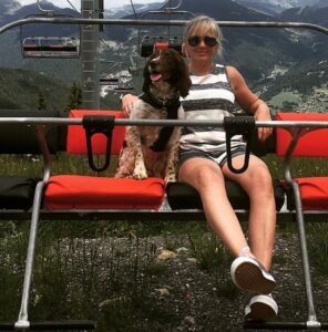On a ski lift with her dog